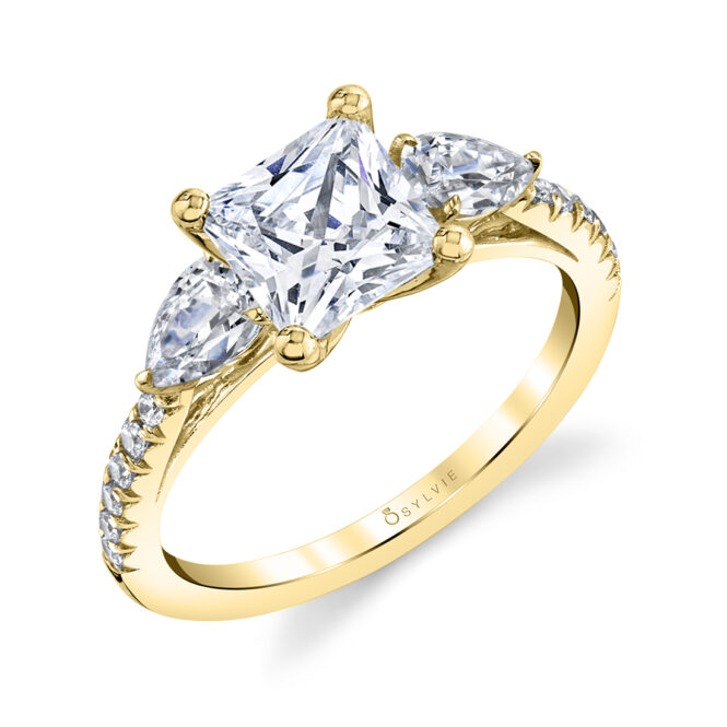 three stone princess cut engagement ring with pear side stones in yellow gold