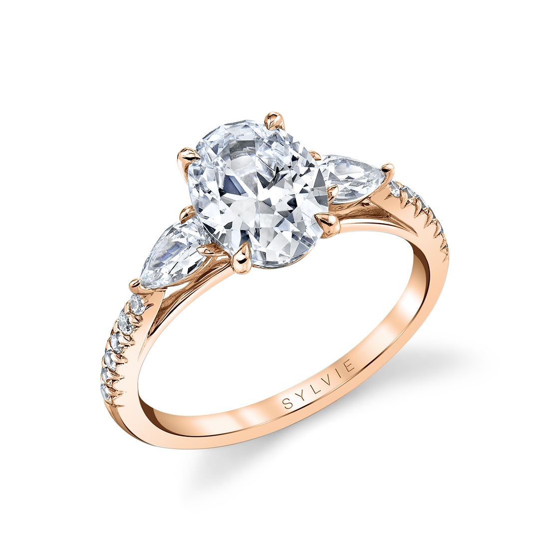 rose gold oval engagement ring with pear side stones