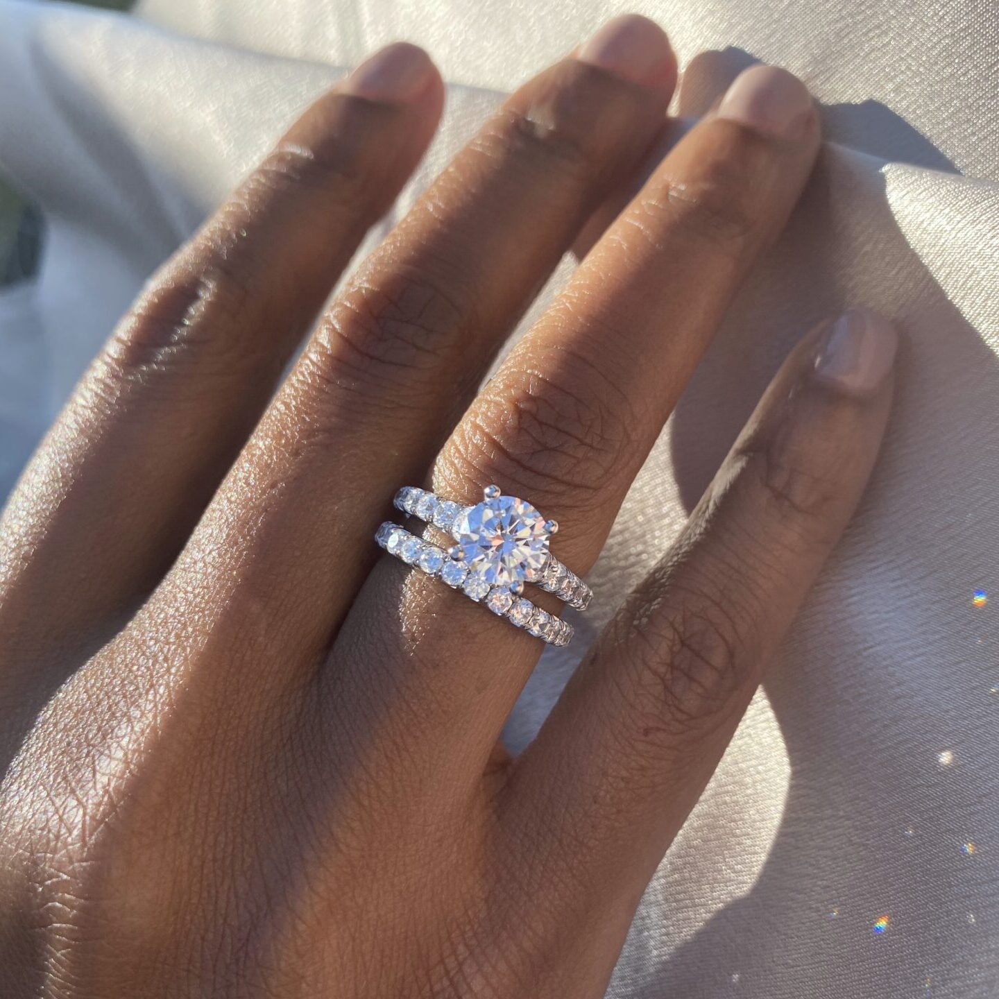 wide band engagement ring and matching wedding band in white gold