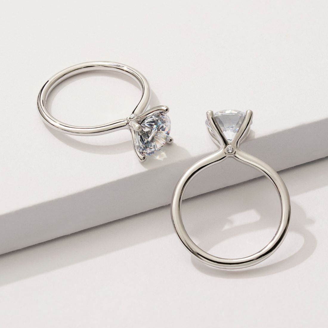 round cut solitaire engagement ring with a peek-a-boo diamond