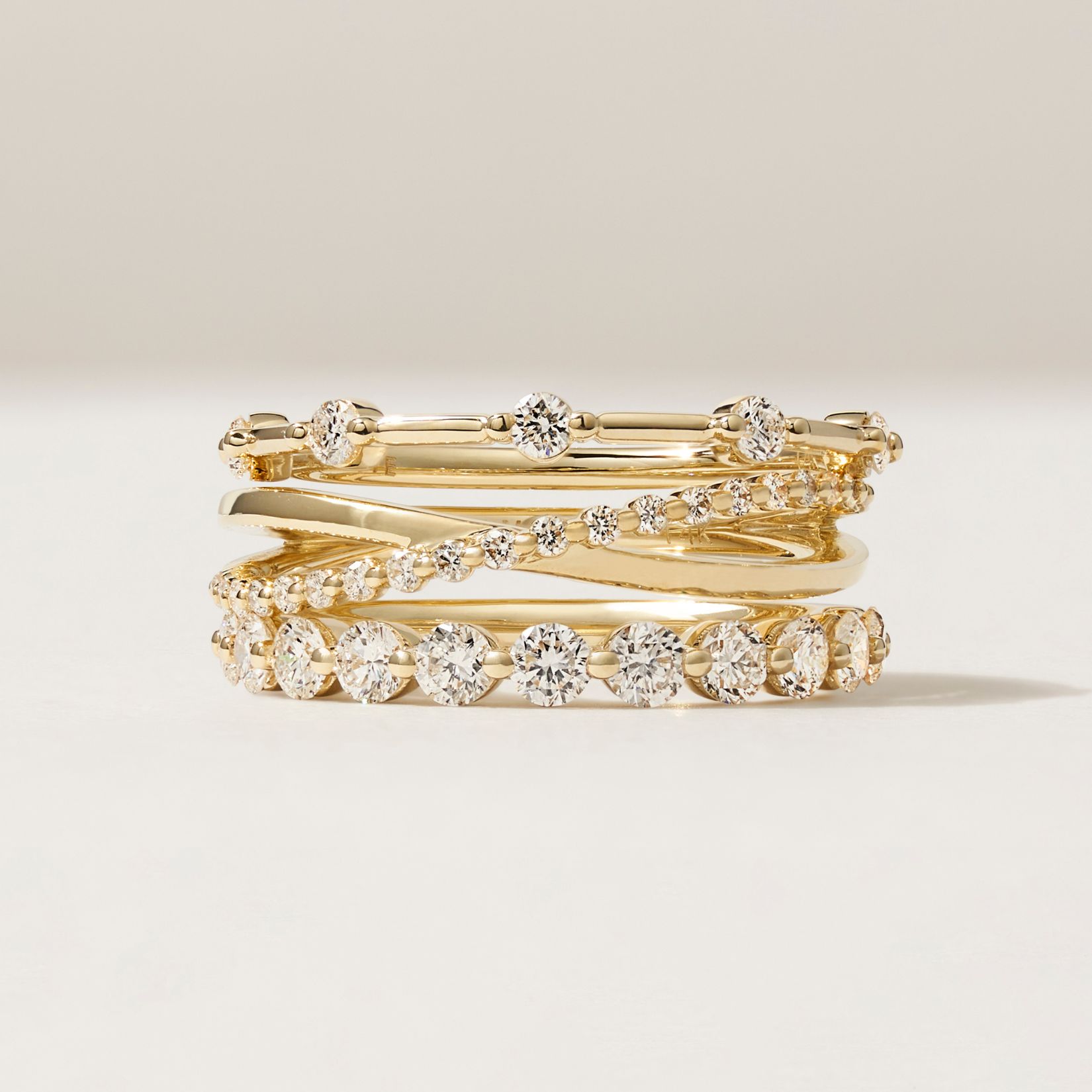 stack of wedding rings on a beige background