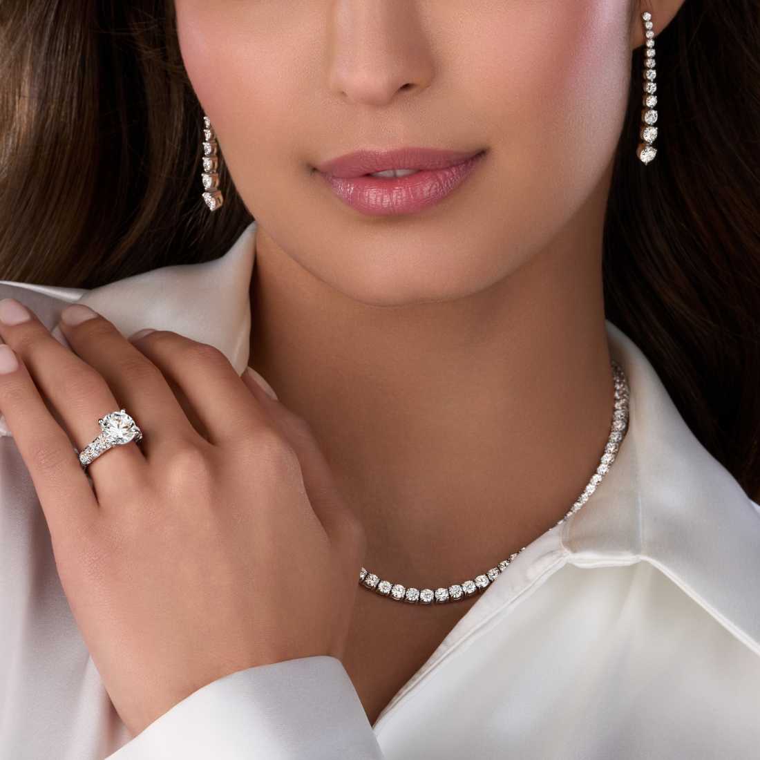 3 carat diamond engagement ring paired with a diamond necklace and diamond earrings