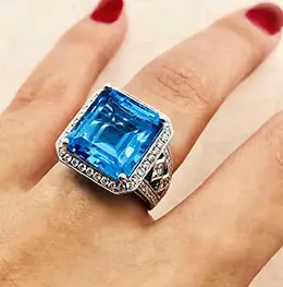 diamond and sapphire ring on woman's finger