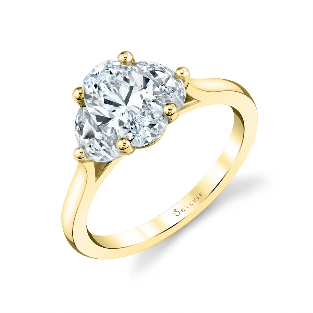 three stone engagement ring in yellow gold