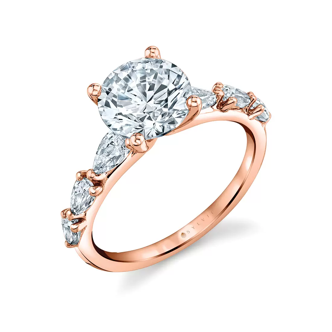 rose gold round cut engagement ring with pear shaped side stones