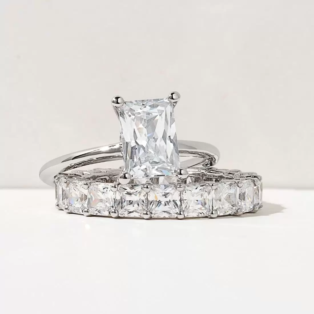radiant cut engagement ring with asscher cut diamond eternity band