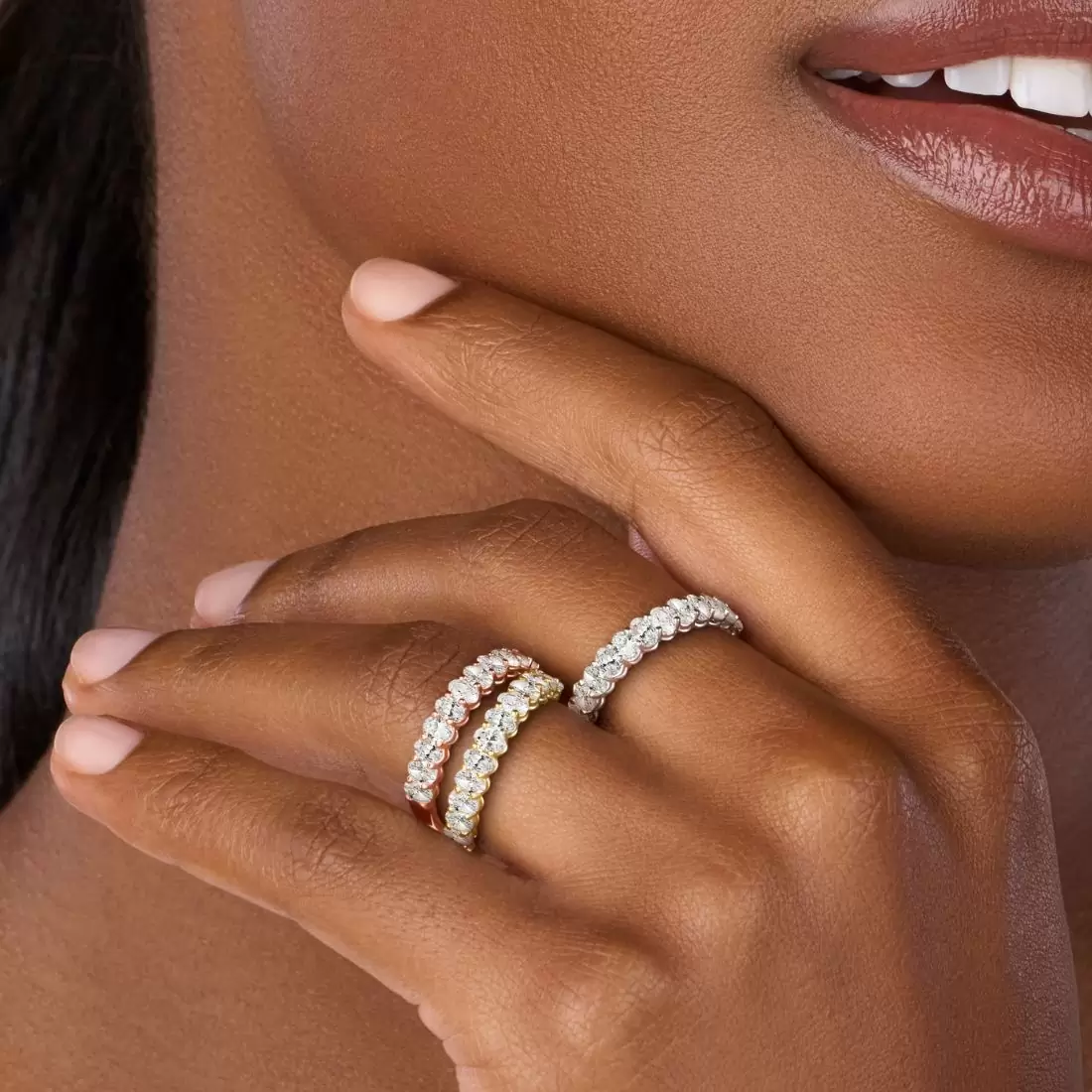 girl wearing a white gold, yellow gold, and a rose gold eternity ring
