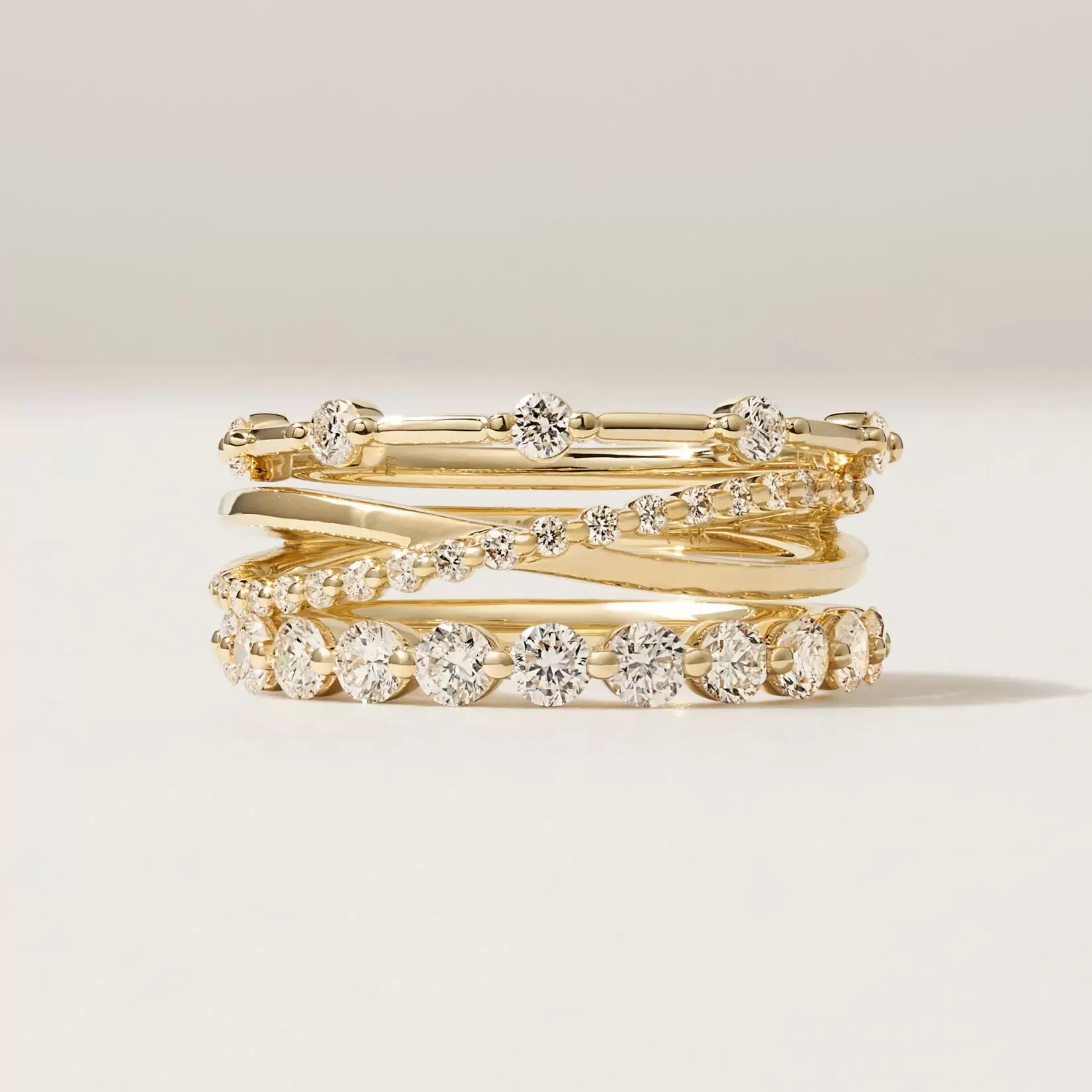 stack of wedding rings on a beige background